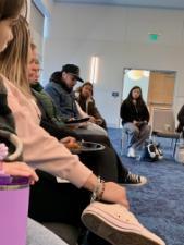 Latinx students eat pizza with Dr. Messer while discussing core values.